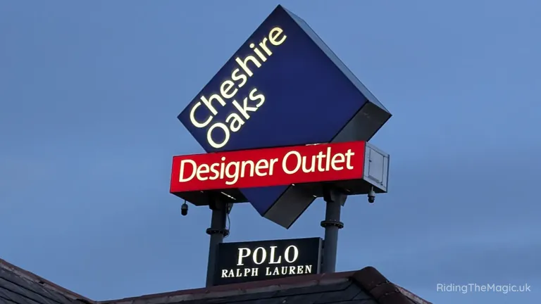 Cheshire Oaks Designer Outlet sign with a Polo Ralph Lauren shop sign beneath.