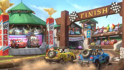 Two cars cross a finish line in a race whilst Cars characters from the film watch from the side lines
