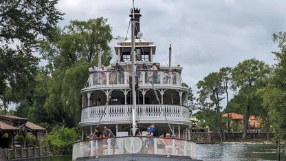 The front of the liberty bell boat as she sails by in Magic Kingdom on a overcast day