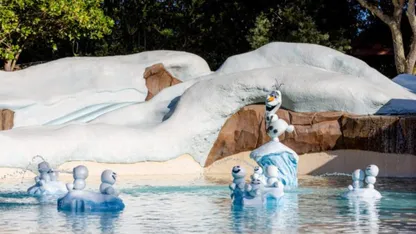 Olaf and snowmen floating in icy water against a snow-covered landscape.