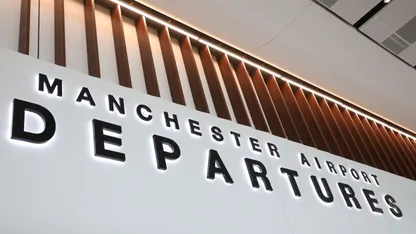 A sign at Manchester Airport that reads "Manchester Airport Departures"