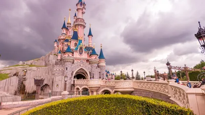 Disney castle with blue sky and clouds in the background