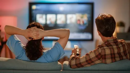 A couple watching TV on a couch