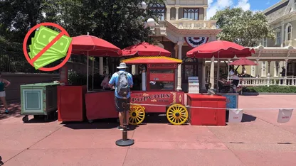 A man stands in line for popcorn at a Main Street popcorn stand