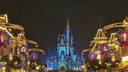 Disney World's Cinderella Castle is decorated for Christmas with lights and wreaths