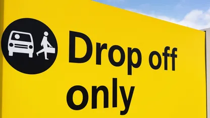A yellow sign with black text that reads "Drop off only"