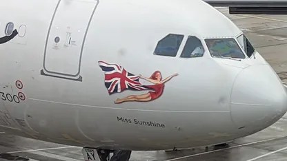 Airplane nose featuring a Union Jack-painted mermaid decal labelled “Miss Sunshine.”