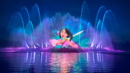 Colourful fountain show featuring a projected animated woman surrounded by blue, pink and purple water jets.