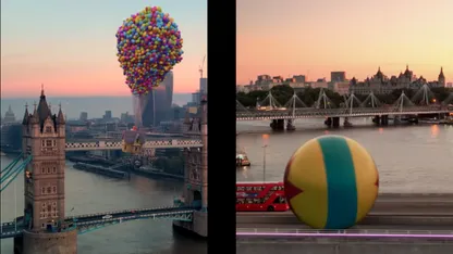 A balloon house floats over the Tower Bridge in London, England