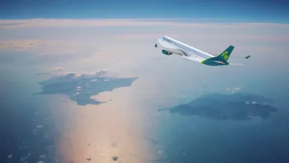 Aer Lingus plane flying over the ocean with clouds and land in the background