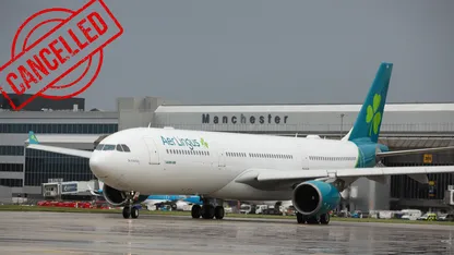 Aer Lingus airplane on the runway with a cancelled sign in the foreground