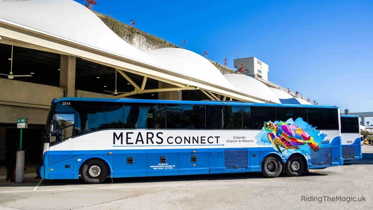 Mears Connect airport shuttle bus parked at a terminal curbside.
