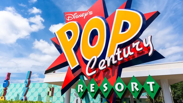 Disney’s Pop Century Resort sign against a blue sky.