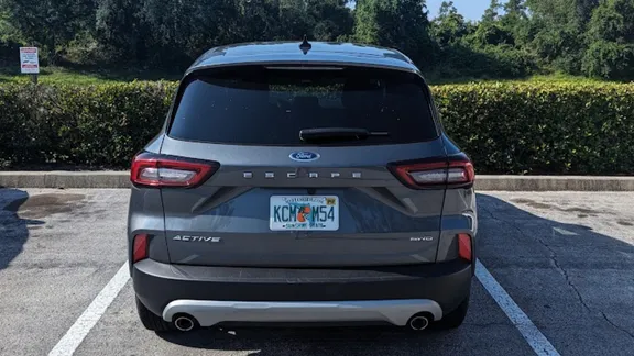 Rear view of a grey Ford Escape SUV parked in a bay.
