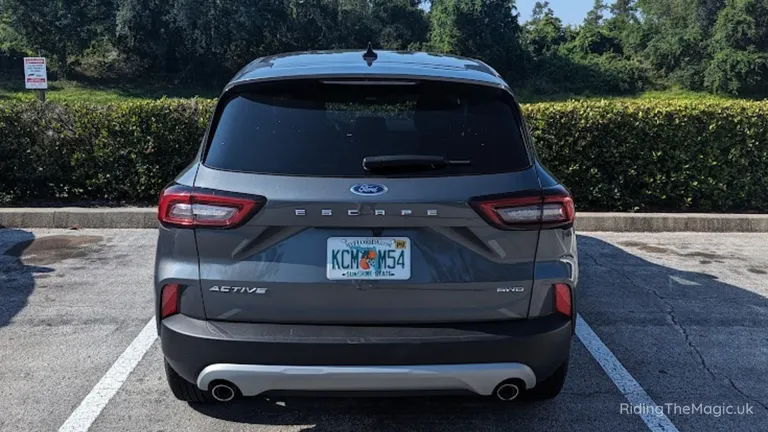 Rear view of a grey Ford Escape SUV parked in a bay.