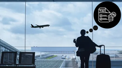 Silhouette of woman with luggage at airport with airplane in background and TAX icon