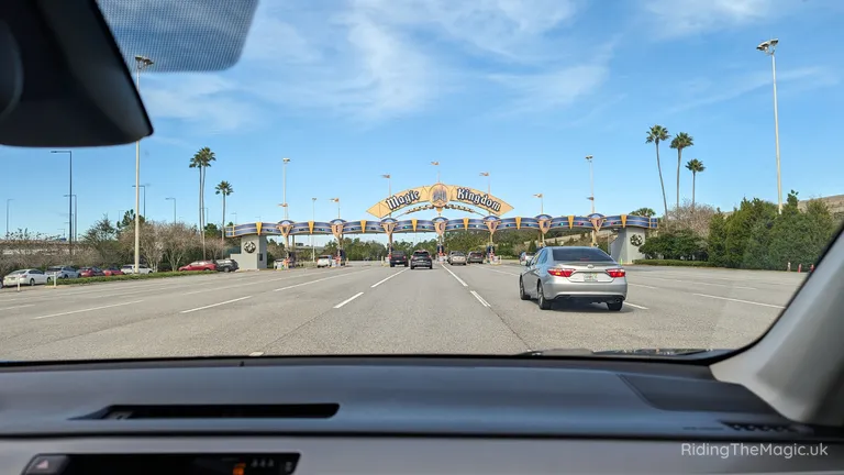 Road approaching the Magic Kingdom entrance beneath a blue sky.