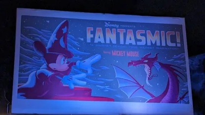 Fantasmic! poster featuring Mickey Mouse as a wizard facing a dragon, with text reading “Disney presents Fantasmic!”