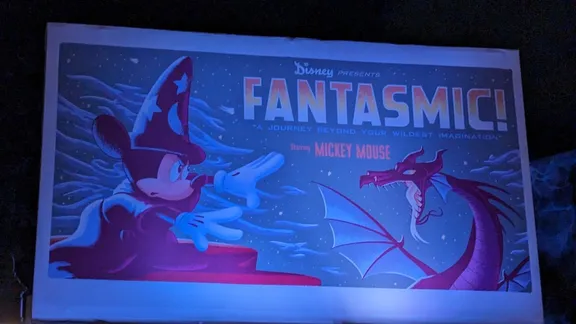 Fantasmic! poster featuring Mickey Mouse as a wizard facing a dragon, with text reading “Disney presents Fantasmic!”