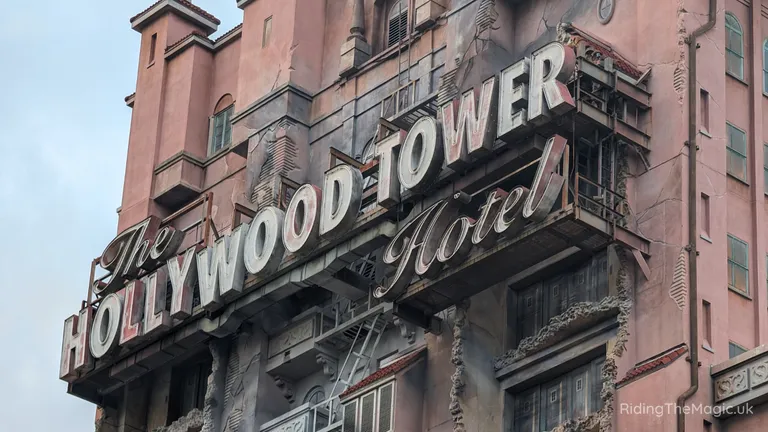 The Hollywood Tower Hotel sign on a weathered pink tower building.