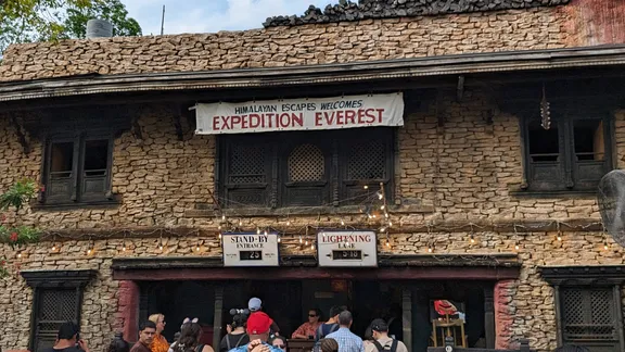Stone Himalayan-themed building with signs reading “Expedition Everest”, “Stand-By Entrance” and “Lightning Lane”.