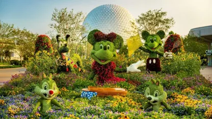 Mickey Mouse and friends in a colourful flower garden, with Epcot’s geodesic sphere in the background.
