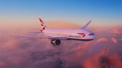 British Airways plane flying over clouds with pink and blue sky in the background