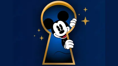 Mickey Mouse peering through a golden keyhole, surrounded by golden stars on a dark blue background.