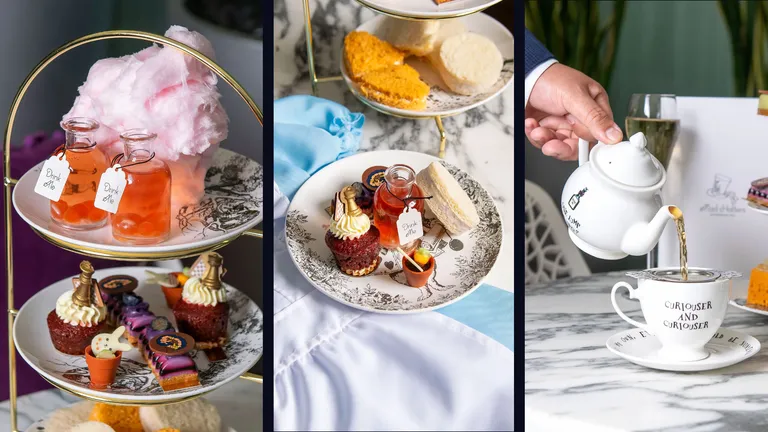 Afternoon tea display with layered desserts, macarons, teacups and a white teapot being poured.