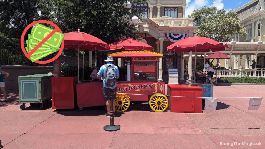 A man stands in line for popcorn at a Main Street popcorn stand