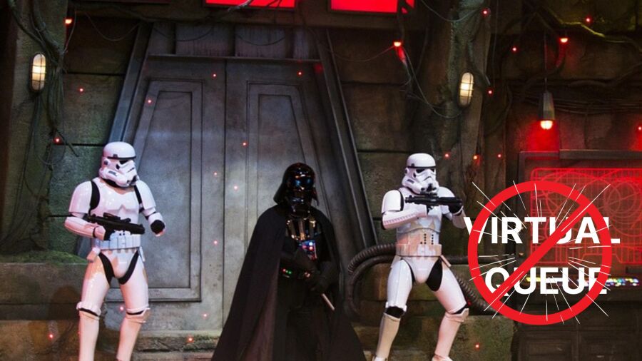 Darth Vader and two stormtroopers stand in front of a door with a red sign