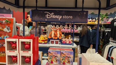 A Disney store with Mickey Mouse plush toys, Mickey's Christmas Carol books, and Mickey Mouse ornaments