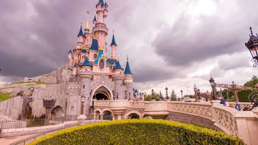 Disney castle with blue sky and clouds in the background