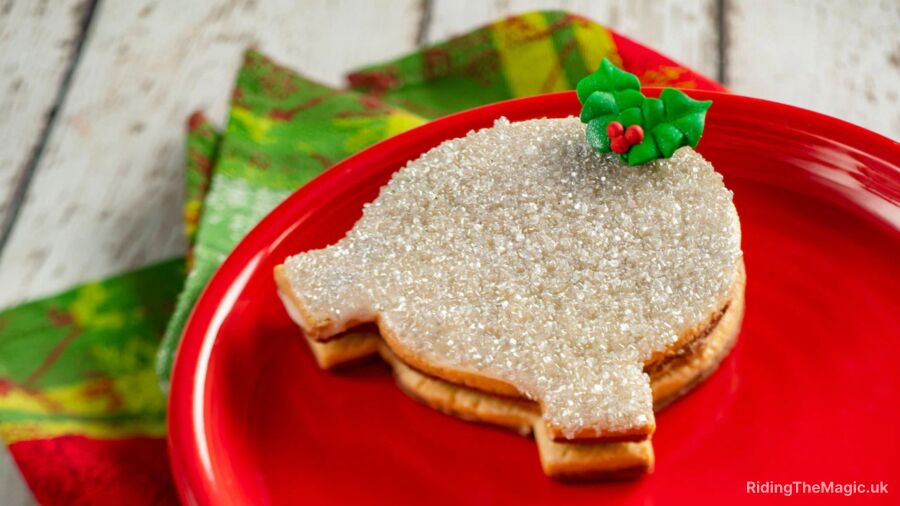 A gingerbread cookie in the shape of a Spaceship Earth on a red plate