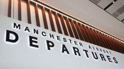 Manchester Airport Departures sign with a modern design and lighting