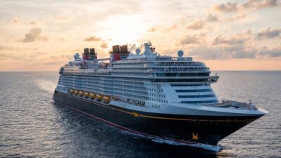 Disney cruise ship sailing in the ocean at sunset