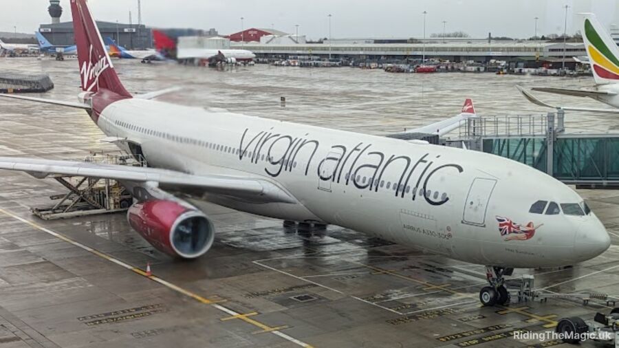 A Virgin Atlantic airplane is parked on the tarmac at an airport