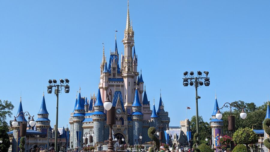 A blue and gold castle with spires and towers in the background