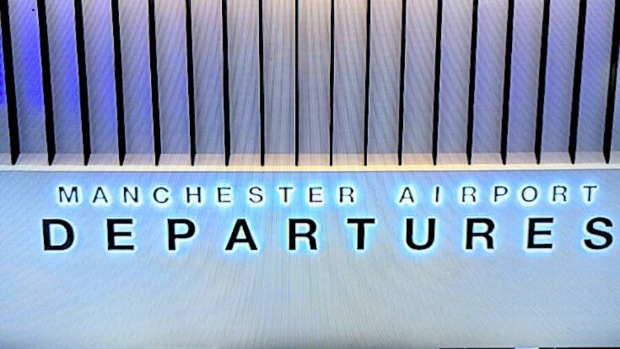 A sign for Manchester Airport Departures with a blue background and white lettering