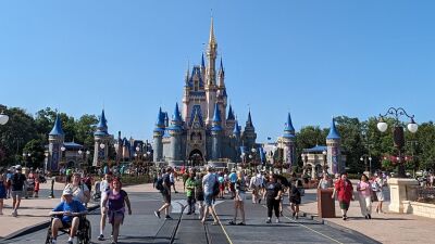 People walking in front of Cinderella's Castle at Walt Disney World in Florida