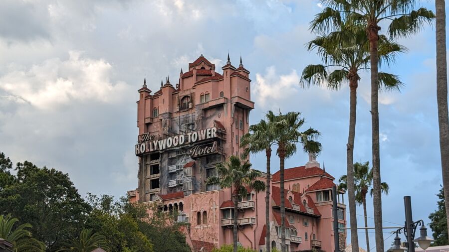 Hollywood Tower Hotel in Orlando, Florida, with a cloudy sky and palm trees