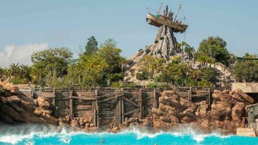 A waterpark with a pirate ship on top of a rock formation