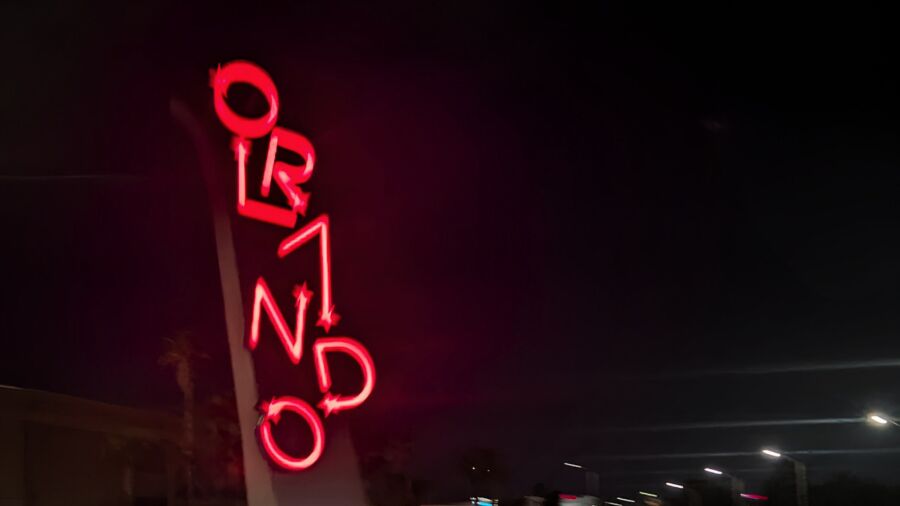 A neon sign for the Ormond Hotel is lit up at night