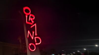 A neon sign for the Ormond Hotel is lit up at night