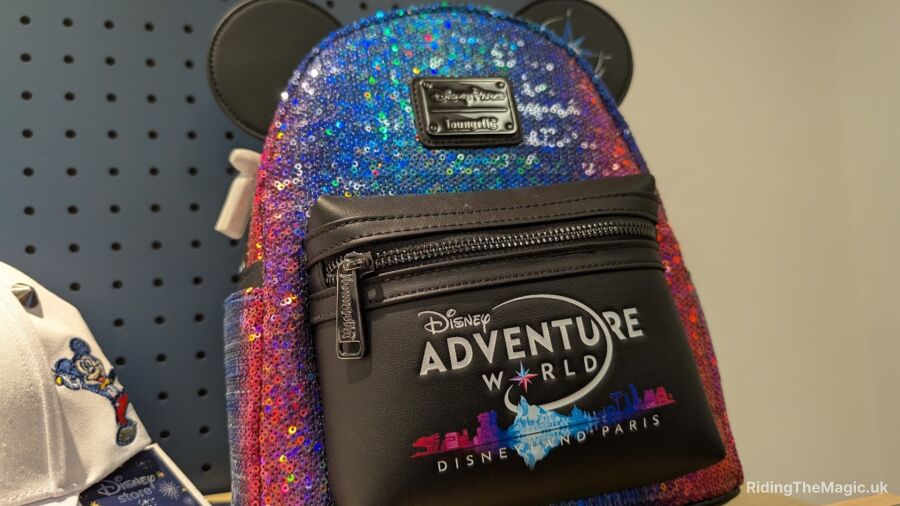 A colorful sequin backpack with Disney Adventure World logo on it