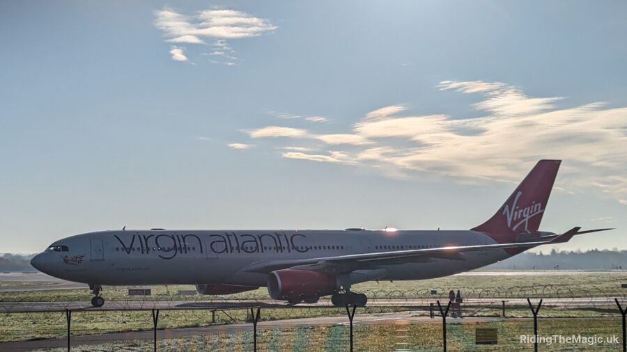A Virgin Atlantic airplane sits on the runway at an airport