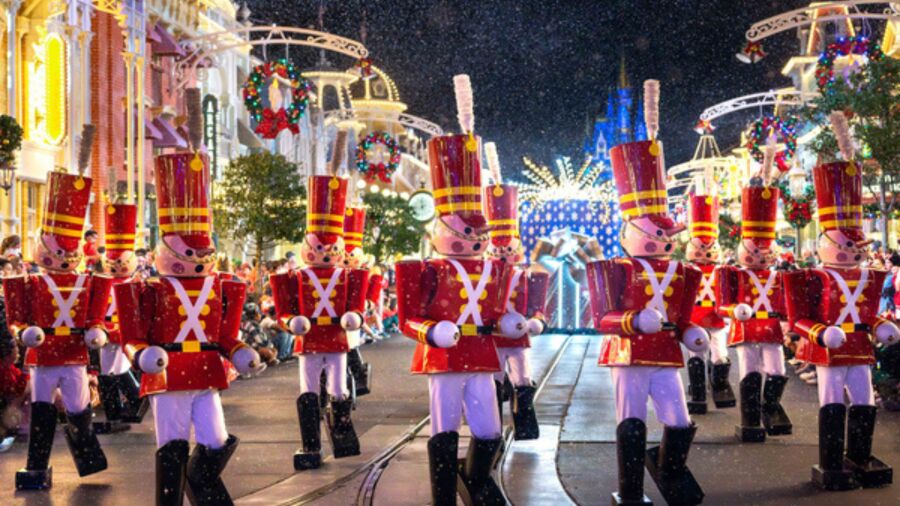 Toy soldiers marching in a parade on a street decorated for Christmas
