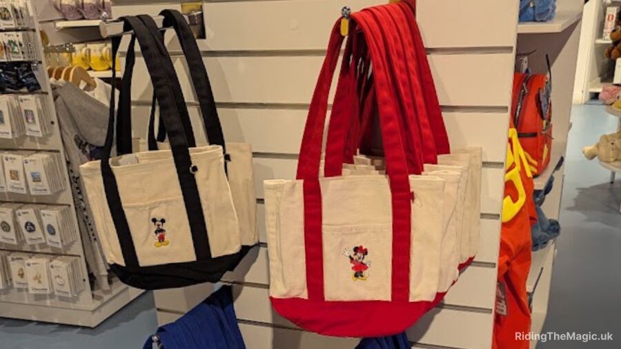 Two Mickey and Minnie Mouse tote bags hanging on a wall in Disney Store Birmingham