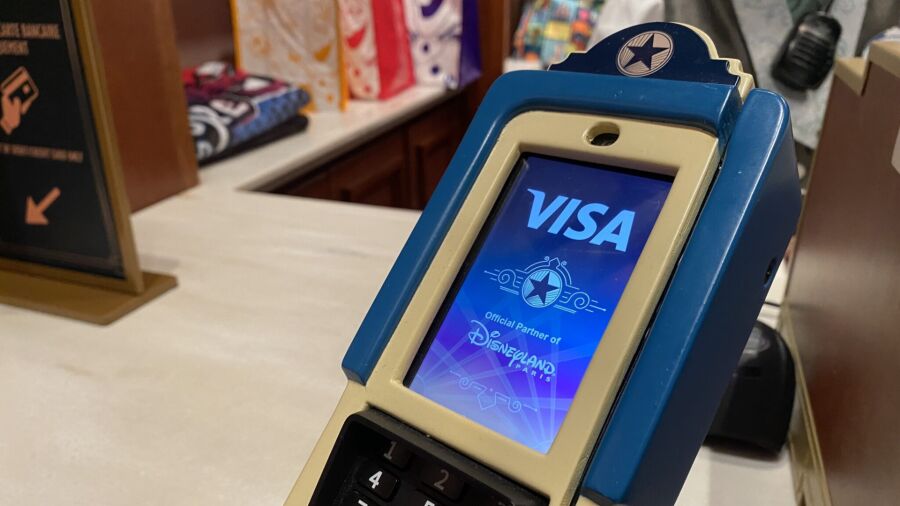 A blue and white device with the word Visa on it is on a counter