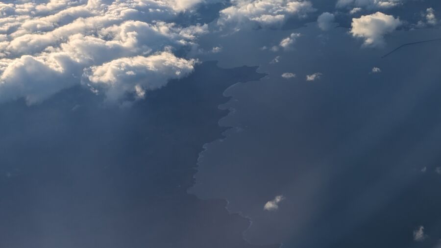 Aerial view of clouds over the ocean and land